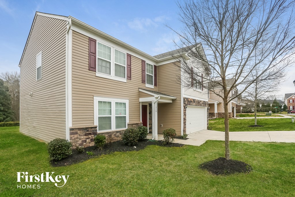 A house with a tree in front of it.