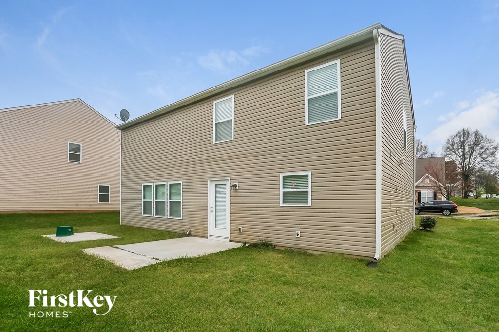 A two-story house with a garage is for sale.