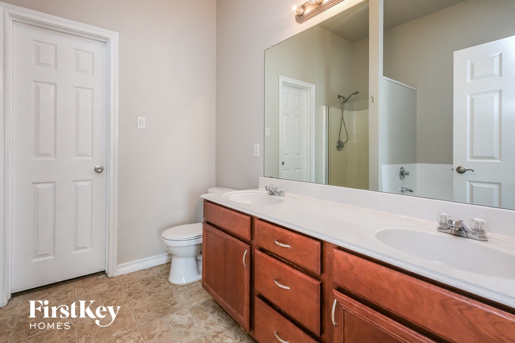 a bathroom with a toilet and a sink and a mirror