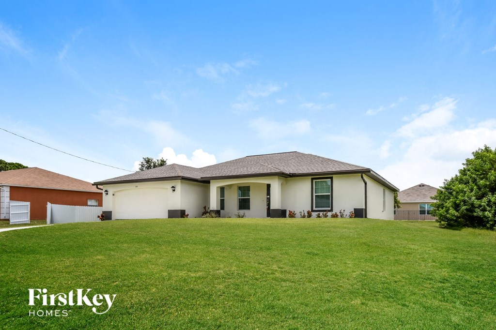 a home with a large lawn in front of it