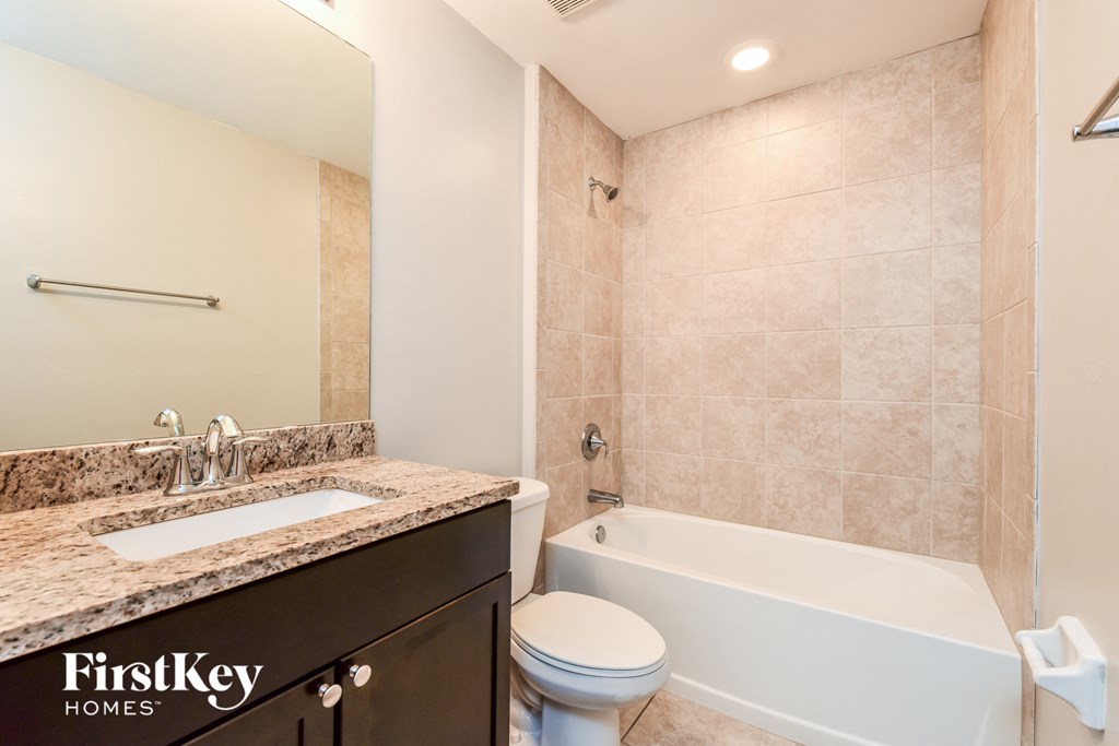 a bathroom with a sink toilet and a bath tub