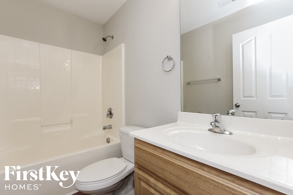 a bathroom with a sink and a toilet and a tub