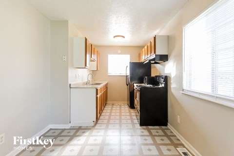 a small kitchen with a stove and a refrigerator