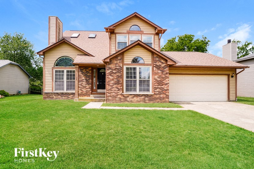 A house with a brown roof and a garage door.