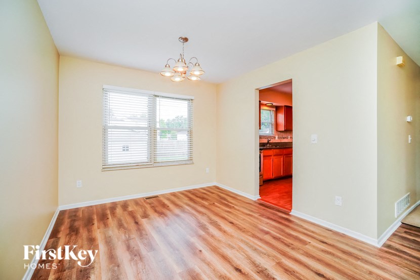 A room with wooden floors and a chandelier.