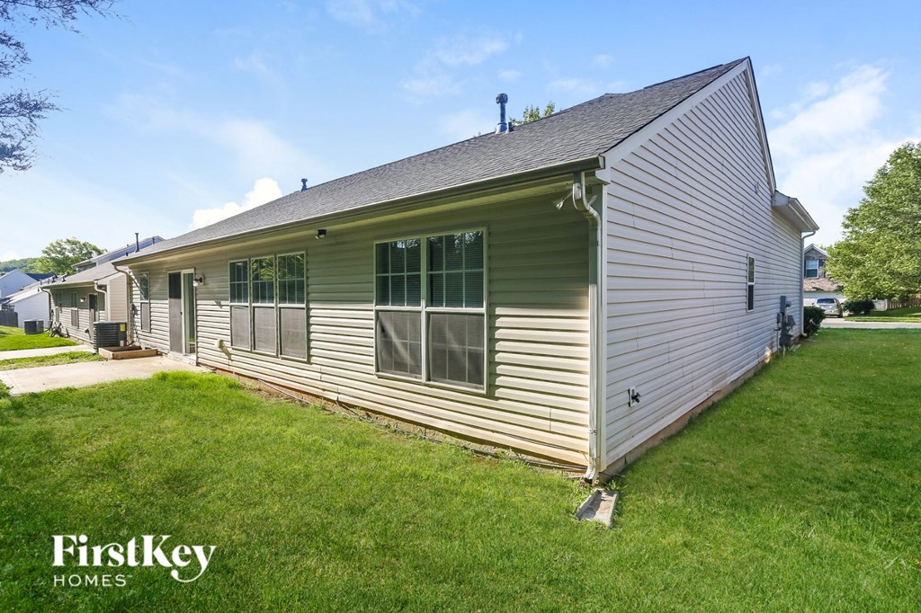 the outside of a house with a lawn and a porch