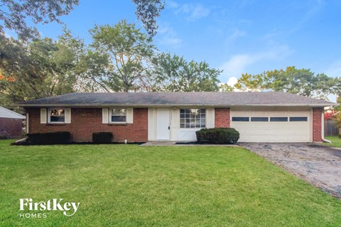 A house with a white garage door is for sale.