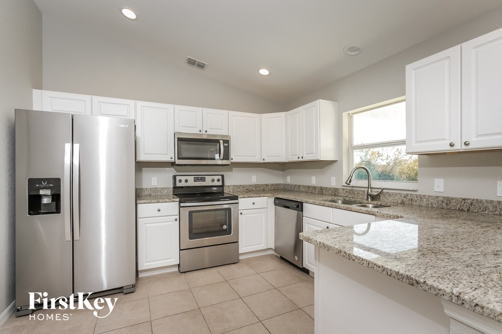 a kitchen with granite counter tops and stainless steel appliances