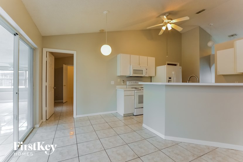 A kitchen with a white counter and cabinets.