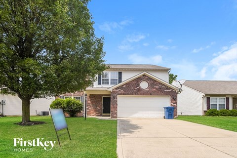 A house with a sign that says FirstKey Homes in front of it.