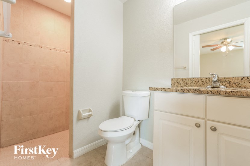 a bathroom with a toilet and a shower and a sink