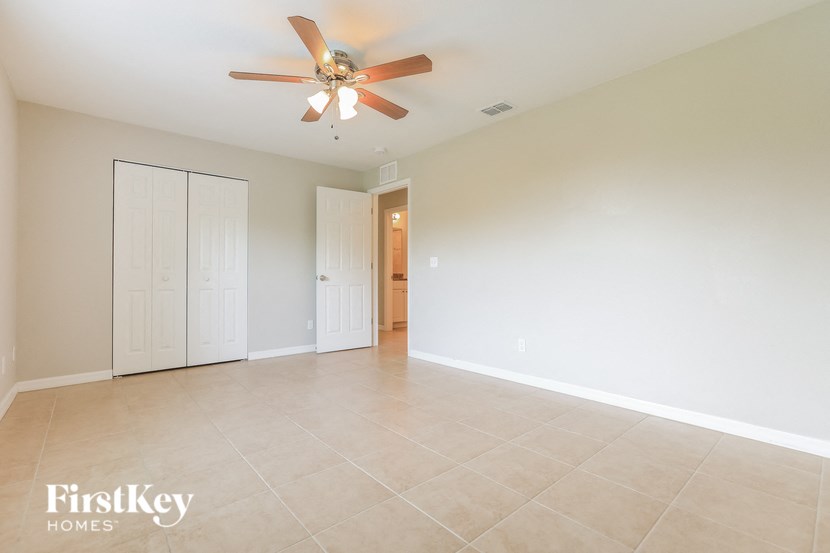 a empty living room with a ceiling fan