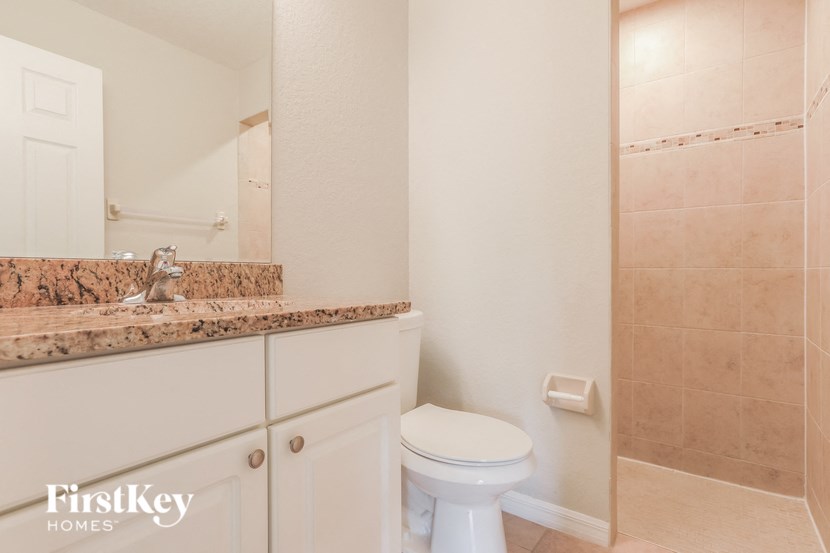 a bathroom with a toilet and a sink and a mirror