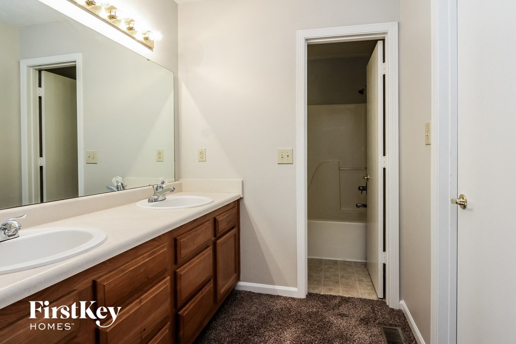 a bathroom with two sinks and a large mirror