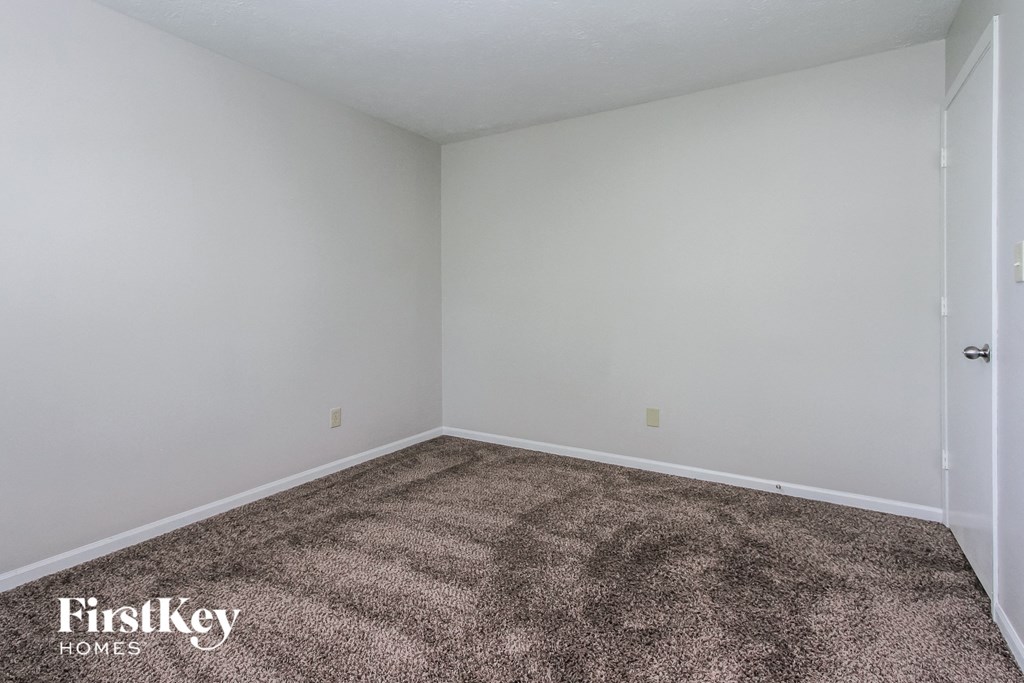 a room with a carpeted floor and white walls