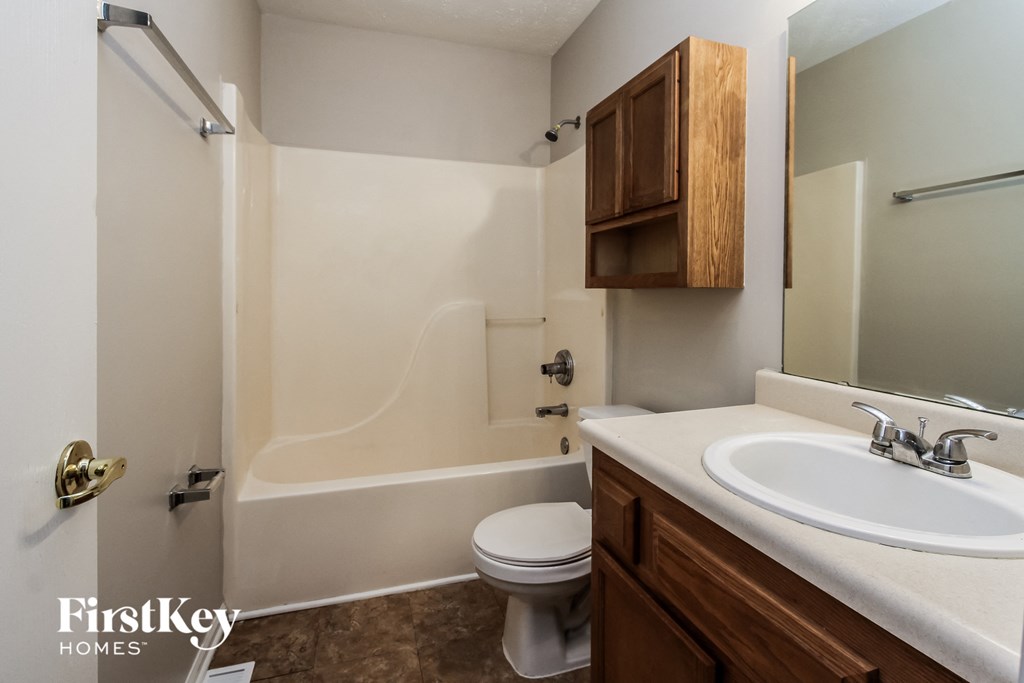 a bathroom with a sink and a toilet and a mirror