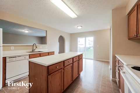 A kitchen with wooden cabinets and a white countertop.