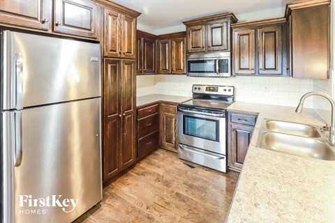 A kitchen with wooden cabinets and stainless steel appliances.