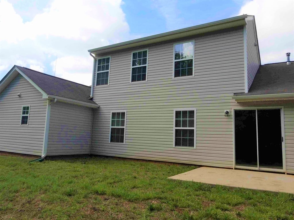 a view of the back of a house and a garage