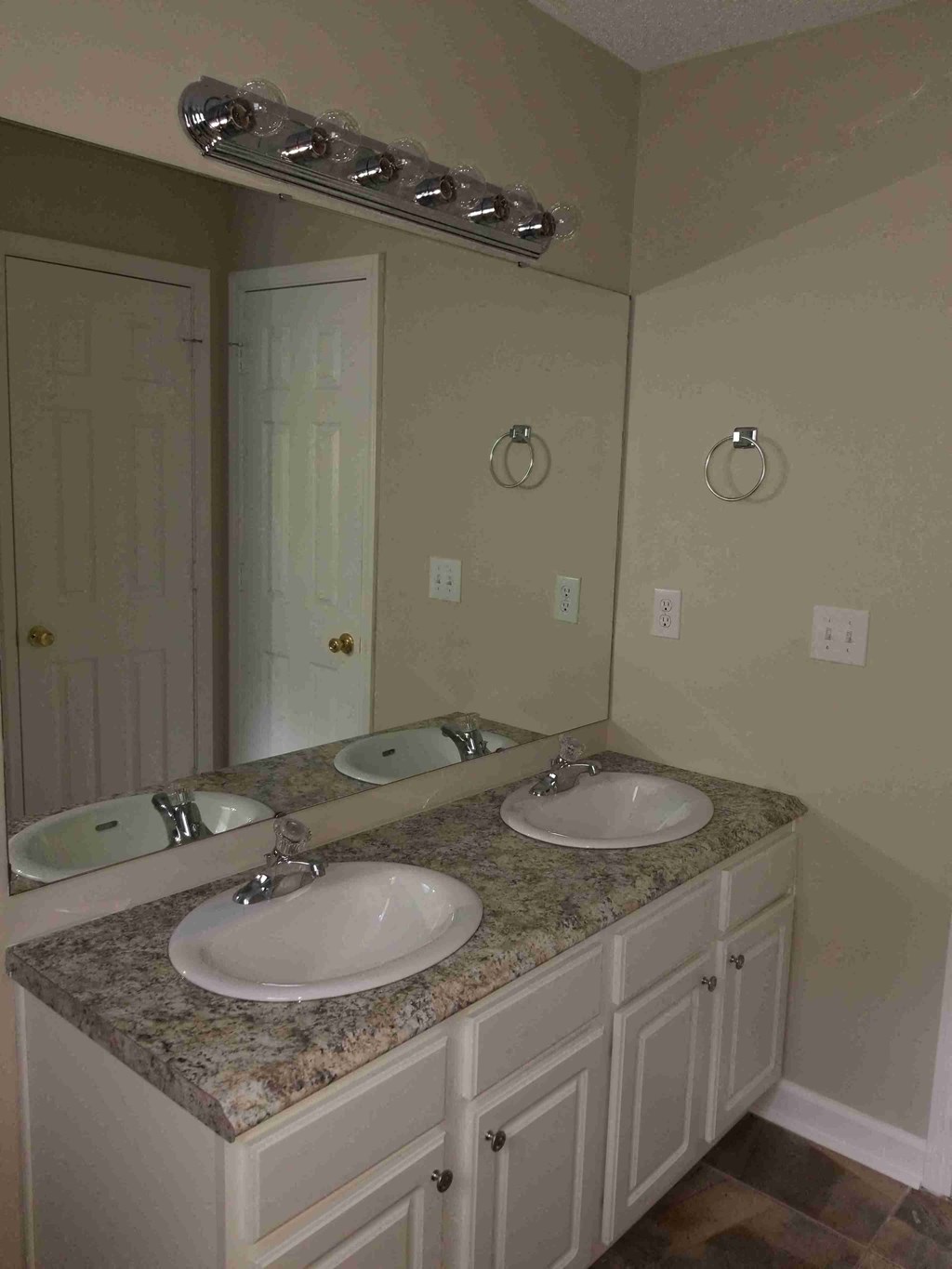 a bathroom with two sinks and a mirror