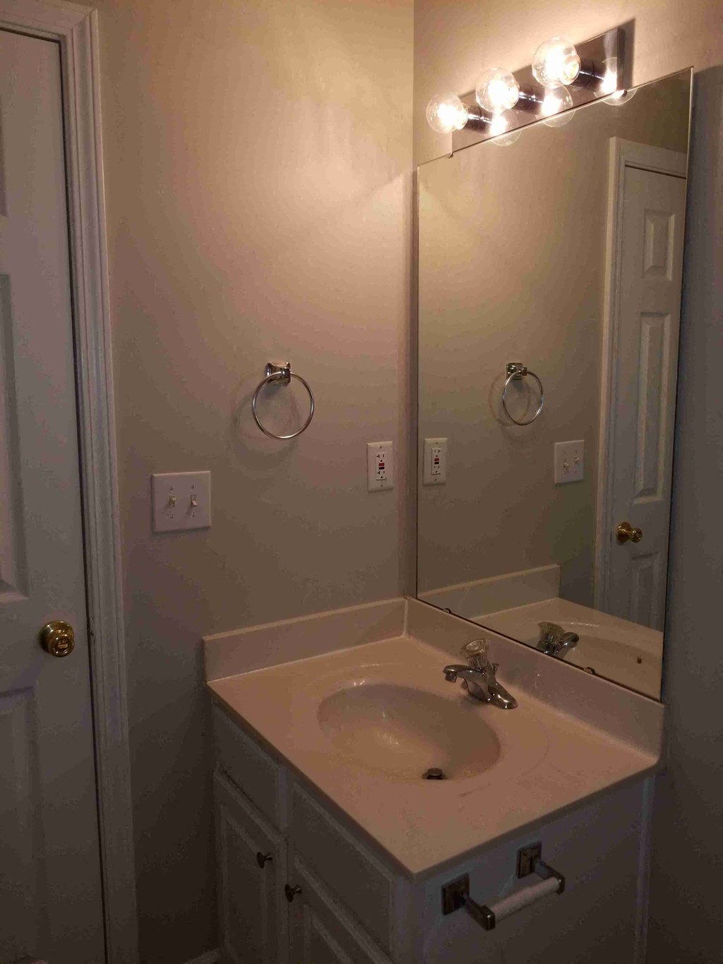 a small bathroom with a sink and a mirror