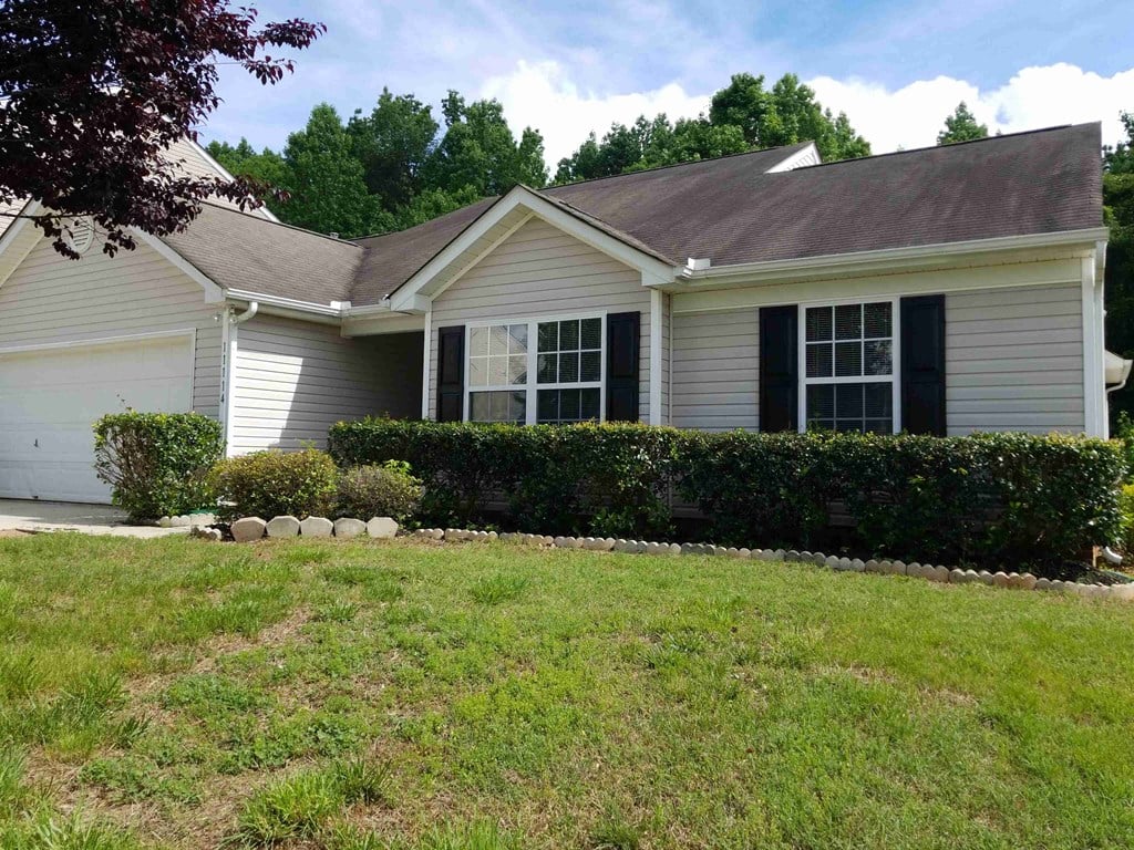 a white house with a lawn in front of it