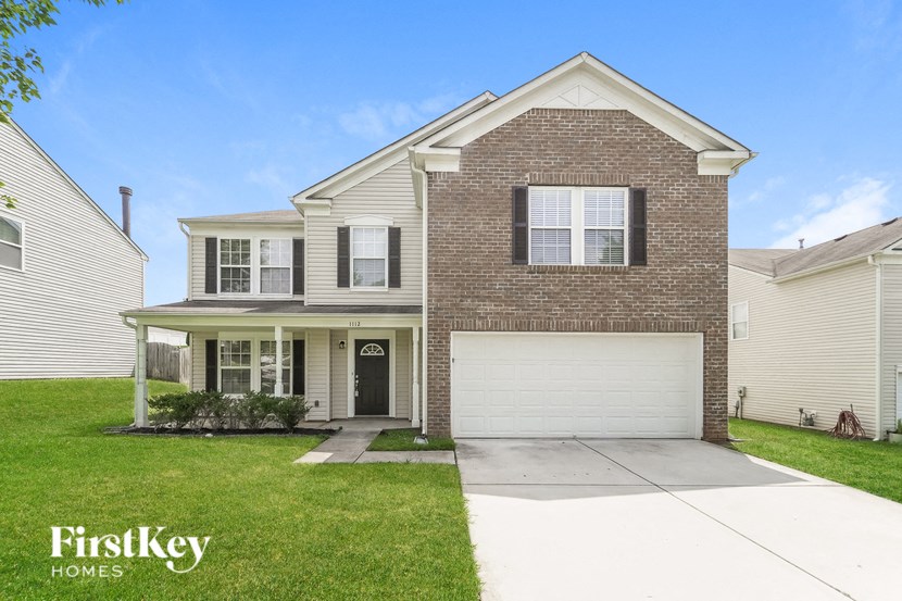 A two-story house with a garage is for sale by FirstKey Homes.