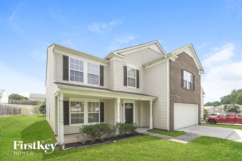 A two-story house with a garage is for sale by FirstKey Homes.
