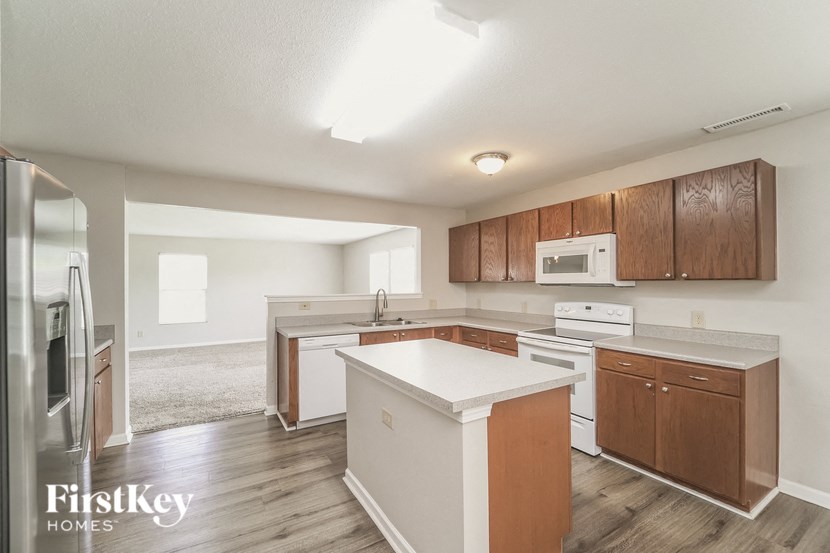 A kitchen with wooden cabinets and a white countertop.