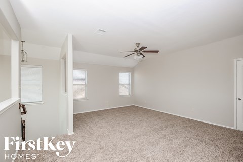 a bedroom with carpet and a ceiling fan
