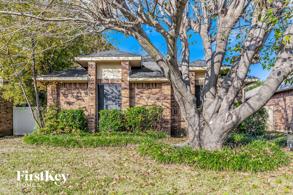 A house with a tree in front of it.