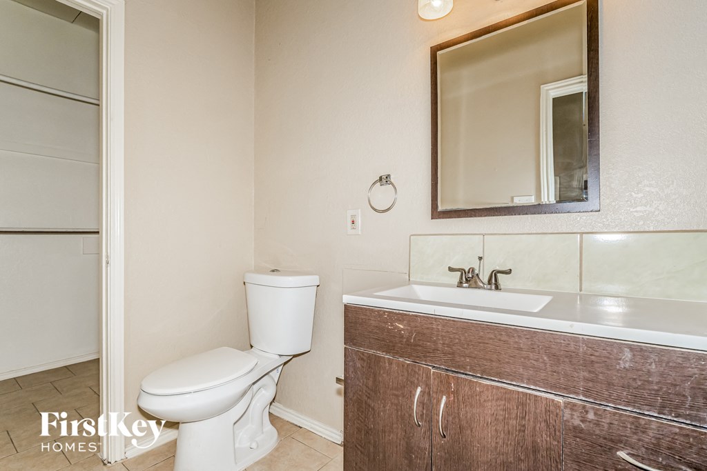 A white toilet sits next to a sink in a bathroom.
