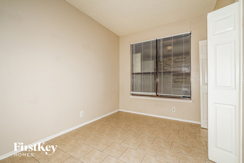 A room with a window and a door.