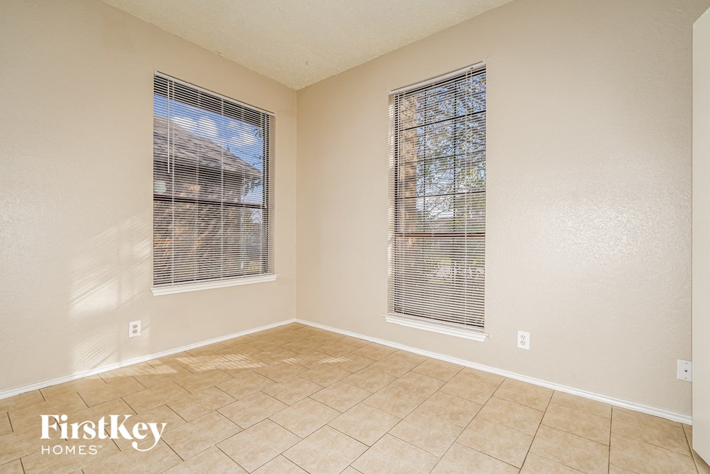 A room with a window and a tiled floor.