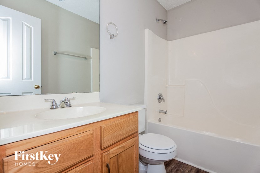 a bathroom with a sink toilet and a mirror