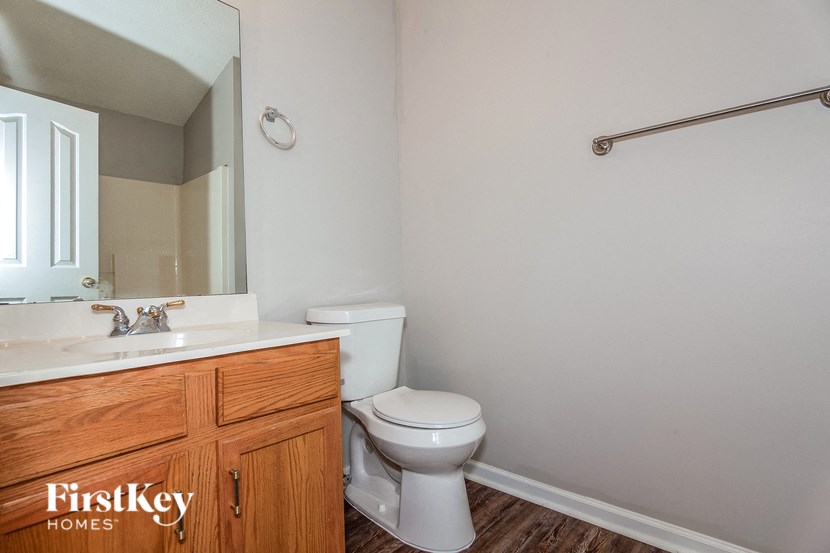a bathroom with a toilet and a sink and a mirror