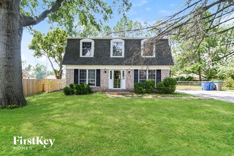 a house with a lawn and a tree