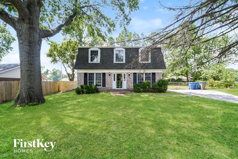 a house with a yard and a large tree