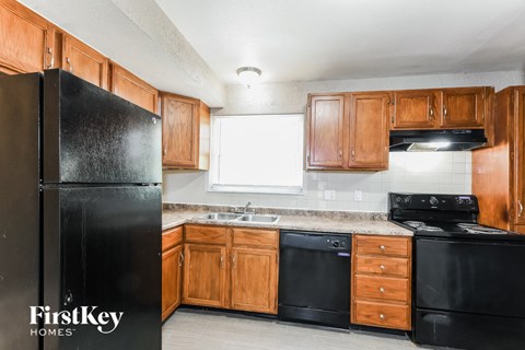 a kitchen with black appliances and wooden cabinets