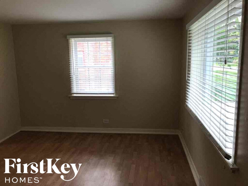 a empty room with wood floors and a window