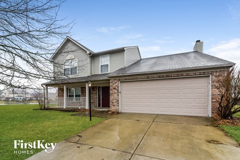 the front of a house with a white garage door