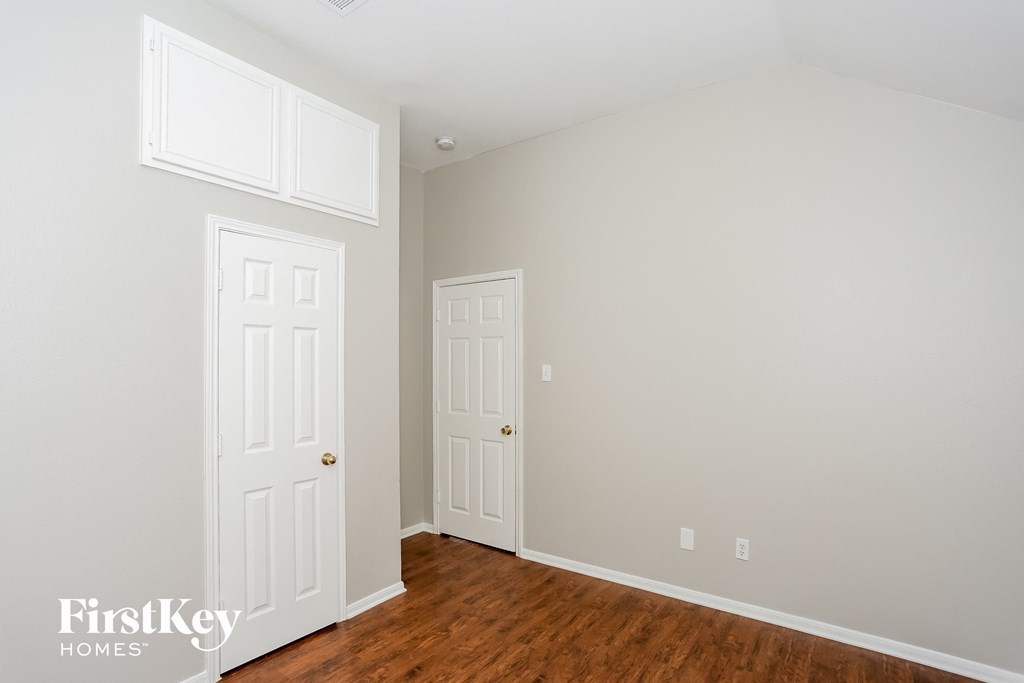 A room with two doors and a window.