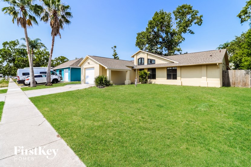 A house with a blue garage door is for sale.