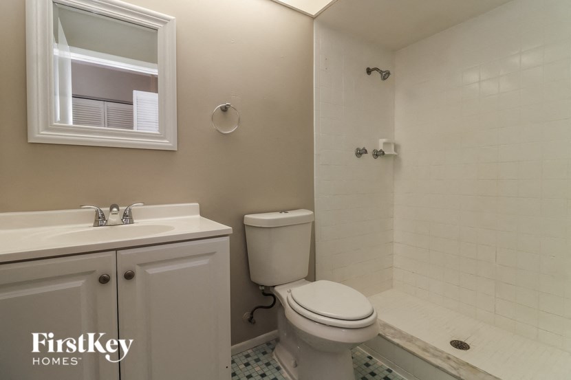 A white bathroom with a toilet, sink, and tub.