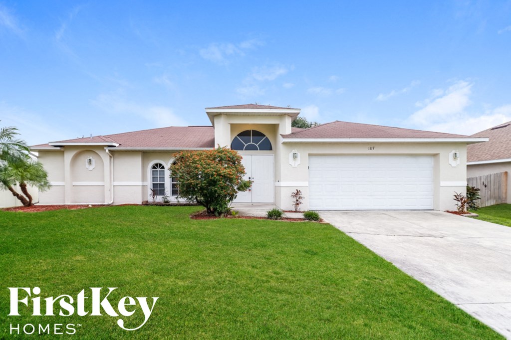 a house with a lawn and a driveway