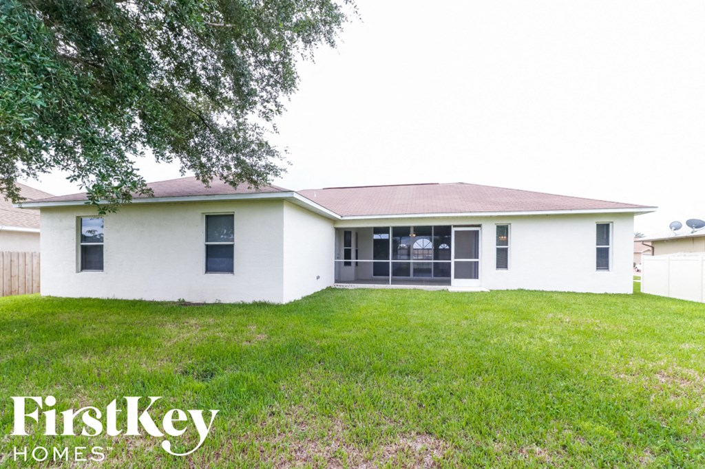 a white house with a yard and a tree