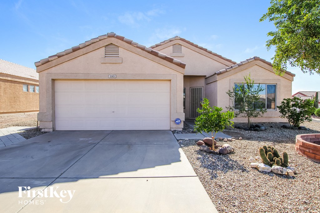 a house with a white garage door and a driveway