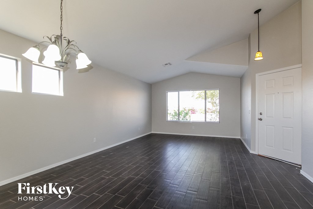 an empty living room with white walls and a white door