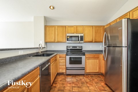 a kitchen with stainless steel appliances and wooden cabinets
