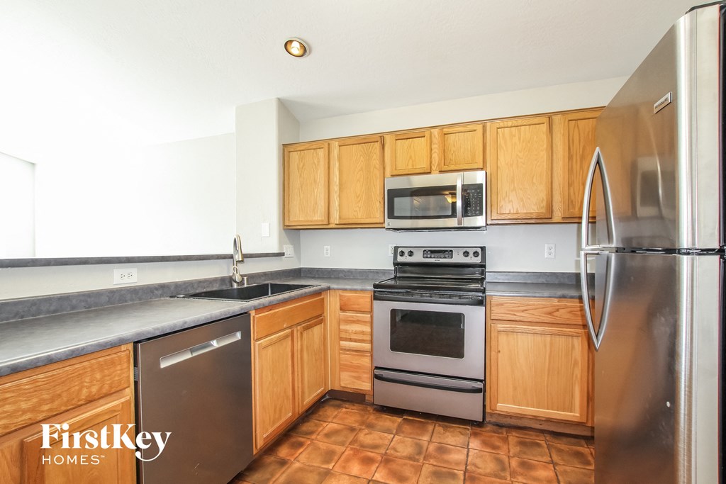 a kitchen with stainless steel appliances and wooden cabinets